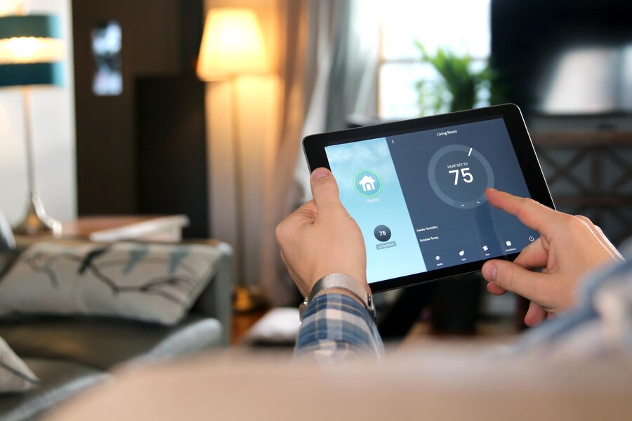 Person adjusting energy management system with tablet