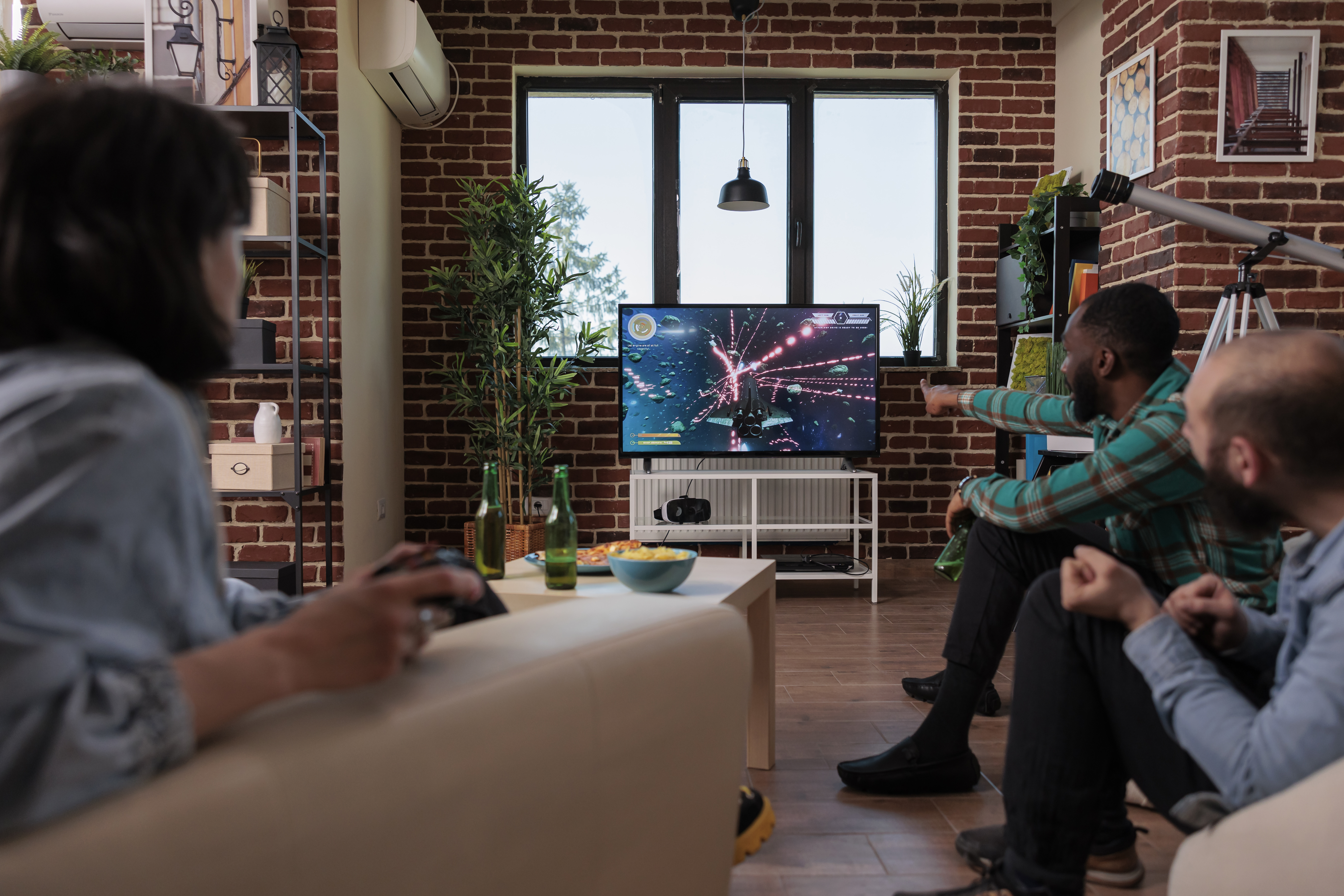Three people watching TV in the living room